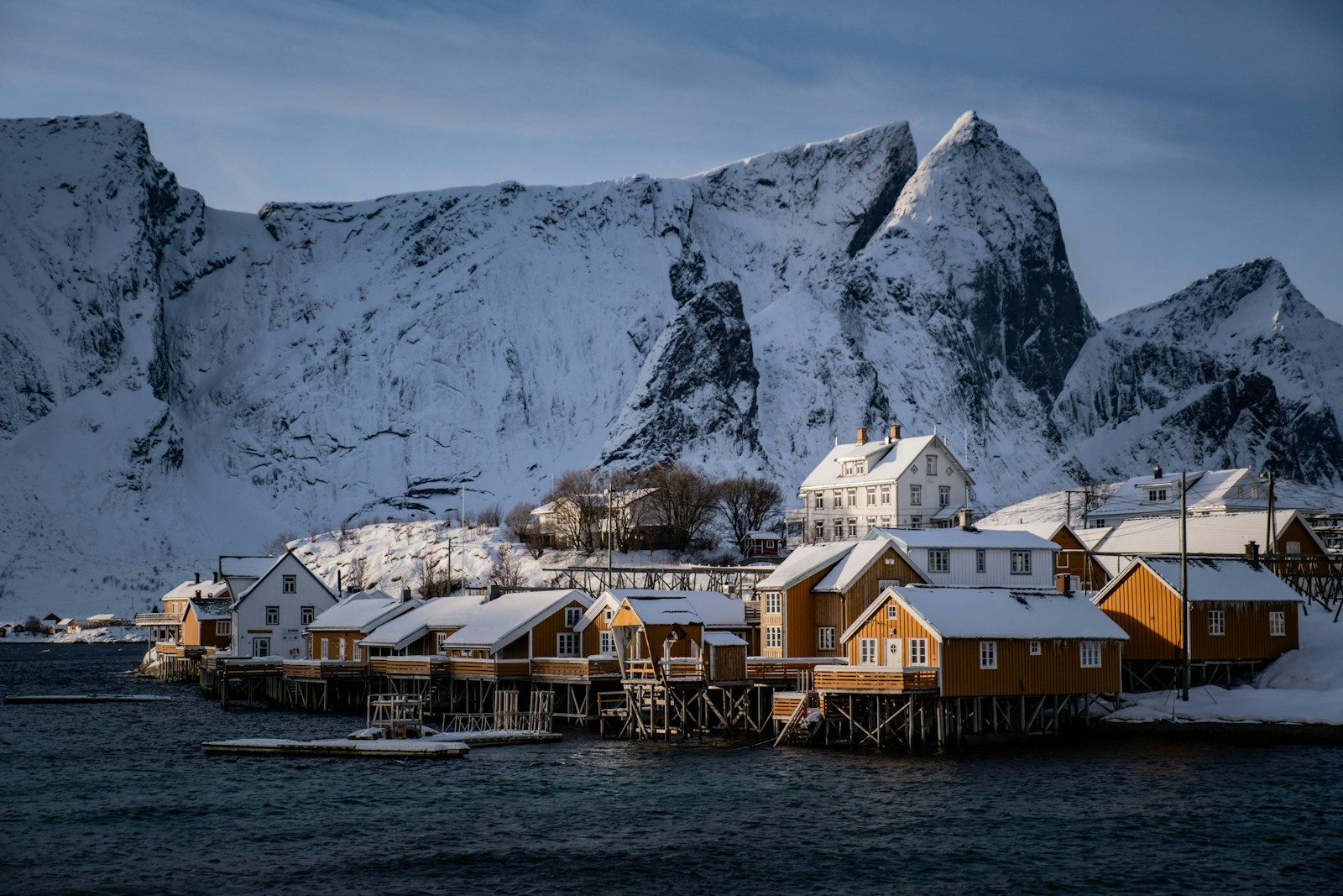 A group of houses sitting on top of a snow covered mountain